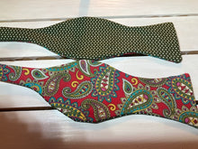 Load image into Gallery viewer, Red and olive Green paisley  self tie bow tie with classic small olive green polka dot print on reverse.