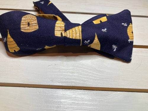 Honey Hives in navy blue  with gold cotton reverse self tie bow tie with up to 20 inch adjustable neck