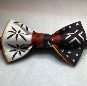 Shades of brown  mudcloth style african print cotton bow tie with with up to 20 inch adjustable black cotton twill strap.
